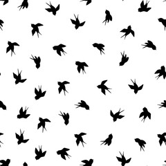 Seamless pattern with black swallow silhouette on white background. Cute bird in flight. Vector illustration. Doodle style. Design for invitation, poster, card, fabric, textile