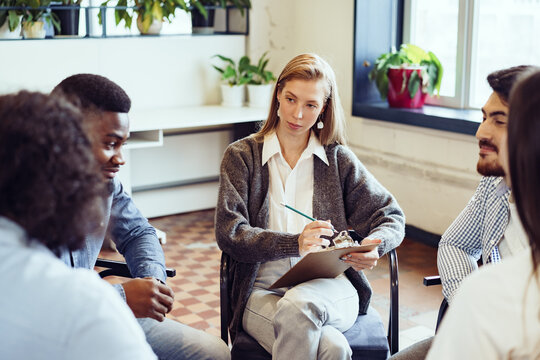 Young people sitting in a circle and having a discussion