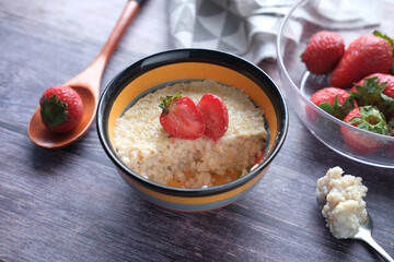 oats flakes and strawberry on wooden table 
