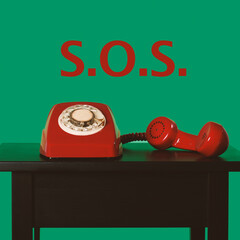 red telephone off the hook and text SOS