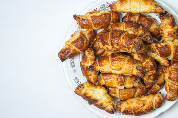 Walnut rolls on a plate on a white background. Homemade baking. Food background