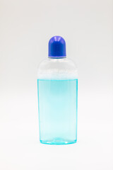 Cosmetic bottle with blue liquid  displayed on white background.