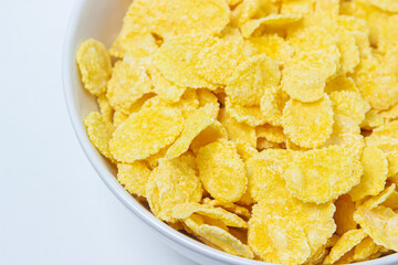 Plate with cornflakes on a white background. Healthy and tasty breakfast.