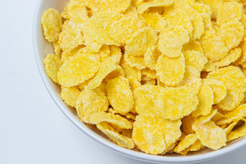 Plate with cornflakes on a white background. Healthy and tasty breakfast.