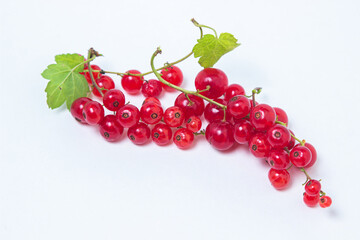 Red currants on a white background. Ripe and tasty berries.