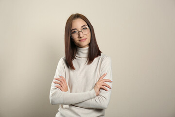 Fototapeta premium Portrait of pretty young woman with gorgeous chestnut hair on light background