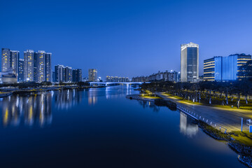 Fototapeta na wymiar Night view of buildings on the bank of the Jiaomen River in Nansha District, Guangzhou