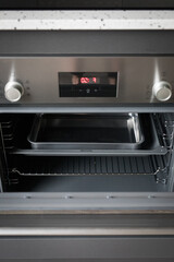 Electric oven with control knobs at home