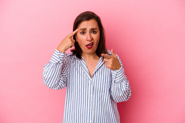 Middle age caucasian woman isolated on pink background showing a disappointment gesture with forefinger.