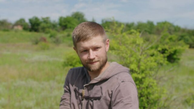 a young guy shoots a bow at a target, in nature, and hits the target, the arrow pierces the target for flight, pulls the bowstring tightly for a shot. Prores 422