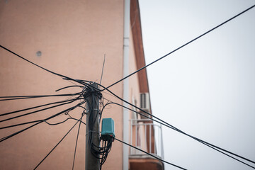 Messy power line with plenty of cables in disorder connecting to an electrical low voltage line to...
