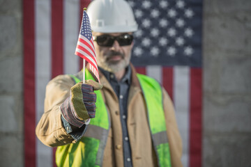 A serious worker man and american flag	 - obrazy, fototapety, plakaty