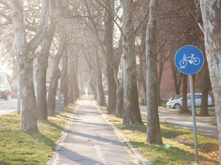Selective blur on a european blue roadsign indicating the presence of a bicycle lane that is mandatory to be used by cyclists and other people using bike as a transportation...