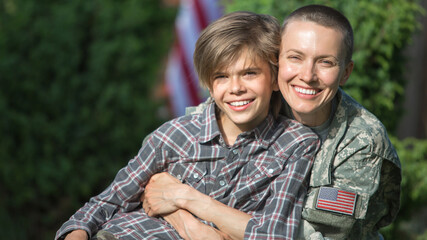 Happy reunion of female mother soldier with family son outdoors	