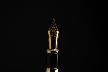 Beautiful fountain pen with ornate nib on black background, closeup