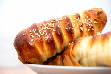 long bun with sesame seeds on a plate