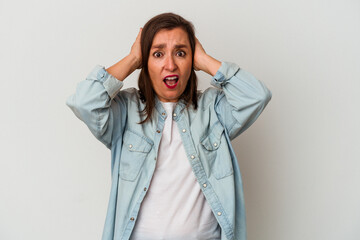 Middle age caucasian woman isolated on white background covering ears with hands trying not to hear too loud sound.