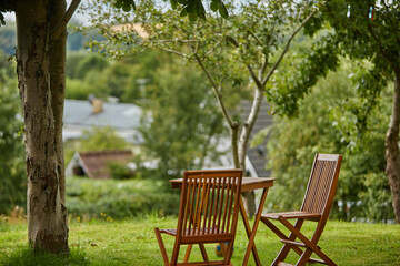 Fototapeta na wymiar brown chair and table in garden by the view