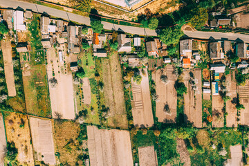 Russia. Aerial View Of Small Town, Village Cityscape Skyline In Summer Day. Residential District, Houses And Vegetable Garden Beds In Bird's-eye View