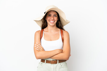 Young caucasian woman wearing a Pamela in summer holidays isolated on white background keeping the arms crossed in frontal position
