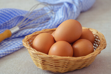 Raw chicken eggs in wicker basket
