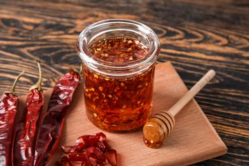 Gardinen Chilischoten Jar of hot honey and dry chili peppers on wooden background  © Pixel-Shot