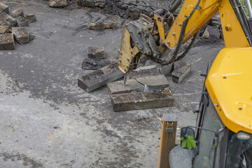 Large heavy duty yellow road work bulldozer refreshes asphalt pavement and curbs
