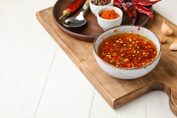 Composition with hot honey and ingredients on light wooden background