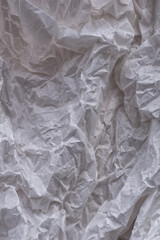 White crumpled paper background, texture for design. Template for creating packaging. Vertical crop.