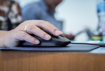 Fototapeta premium Female hands clicking on computer mouse. E-leaning network communication, Smart businesswoman learning at conference online meeting technology classroom at university for training in technology