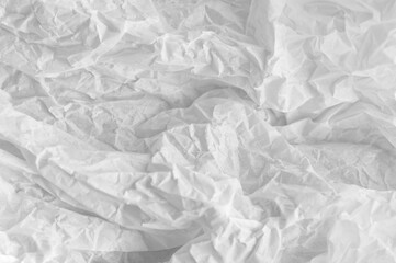 Abstract white background. White crumpled paper. Selective focus.