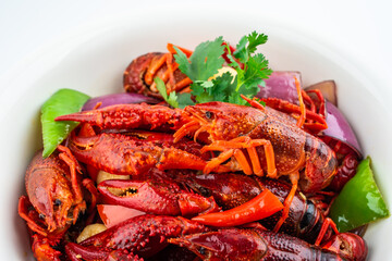 Spicy crayfish in a pot on white background