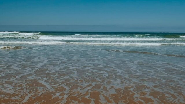 Spectacular view of Bamburgh Castle beach, a pristine, sandy beach, backed by sand dunes in Northumberland, England, UK