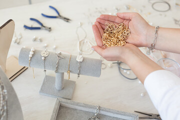Professional jewelry designer making handmade jewelry in studio workshop. Fashion, creativity and handmade concept