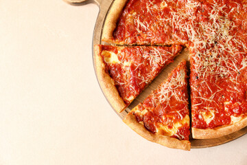 Board with tasty Chicago-style pizza on color background, closeup