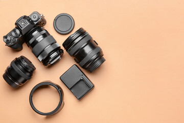 Modern photographer's equipment on color background