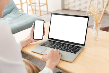 computer screen,cell phone blank mockup.hand woman work using laptop texting mobile.white...