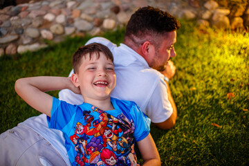 Father with his son lying down in the garden