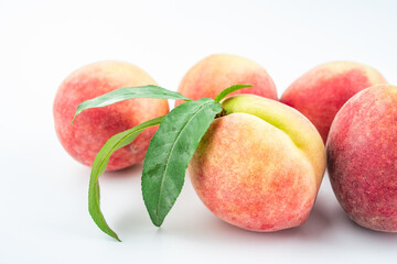 Fresh peaches on white background