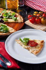 Brazilian-style pizza with mozzarella, sun-dried tomatoes and arugula.