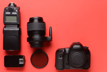 Modern photographer's equipment on color background