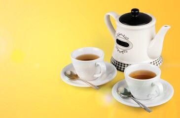 Herbal tea with white tea cups and teapot on a kitchen desk
