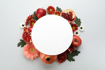 Flat lay composition with Rosh Hashanah holiday attributes and card on white background. Space for...