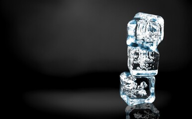 Crystal clear natural ice block on a dark surface.