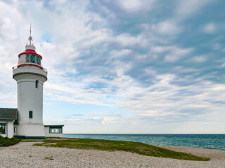 The lighthouse on the beach. The Lighthouse - Sletterhage fyr was built in 1894 and is still working in Denmark today - obrazy, fototapety, plakaty
