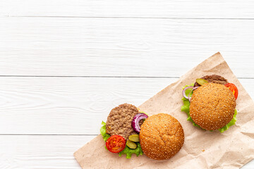 Top view of hamburgers with beef meat steak and vegetales