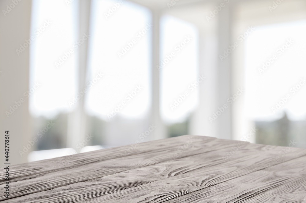 Poster blank wooden table top on blur room background