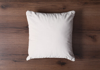 Blank soft pillow on wooden background, top view
