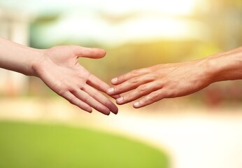 Concept of human relation. Hand of male and female reaching to each other.