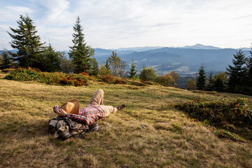 Woman hiker resting after climbing  at sunset - 440779855